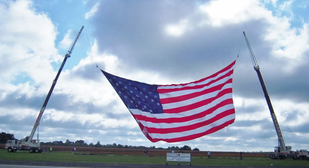 Two of CSC's crane's hoisting the world's largest flying USA flag