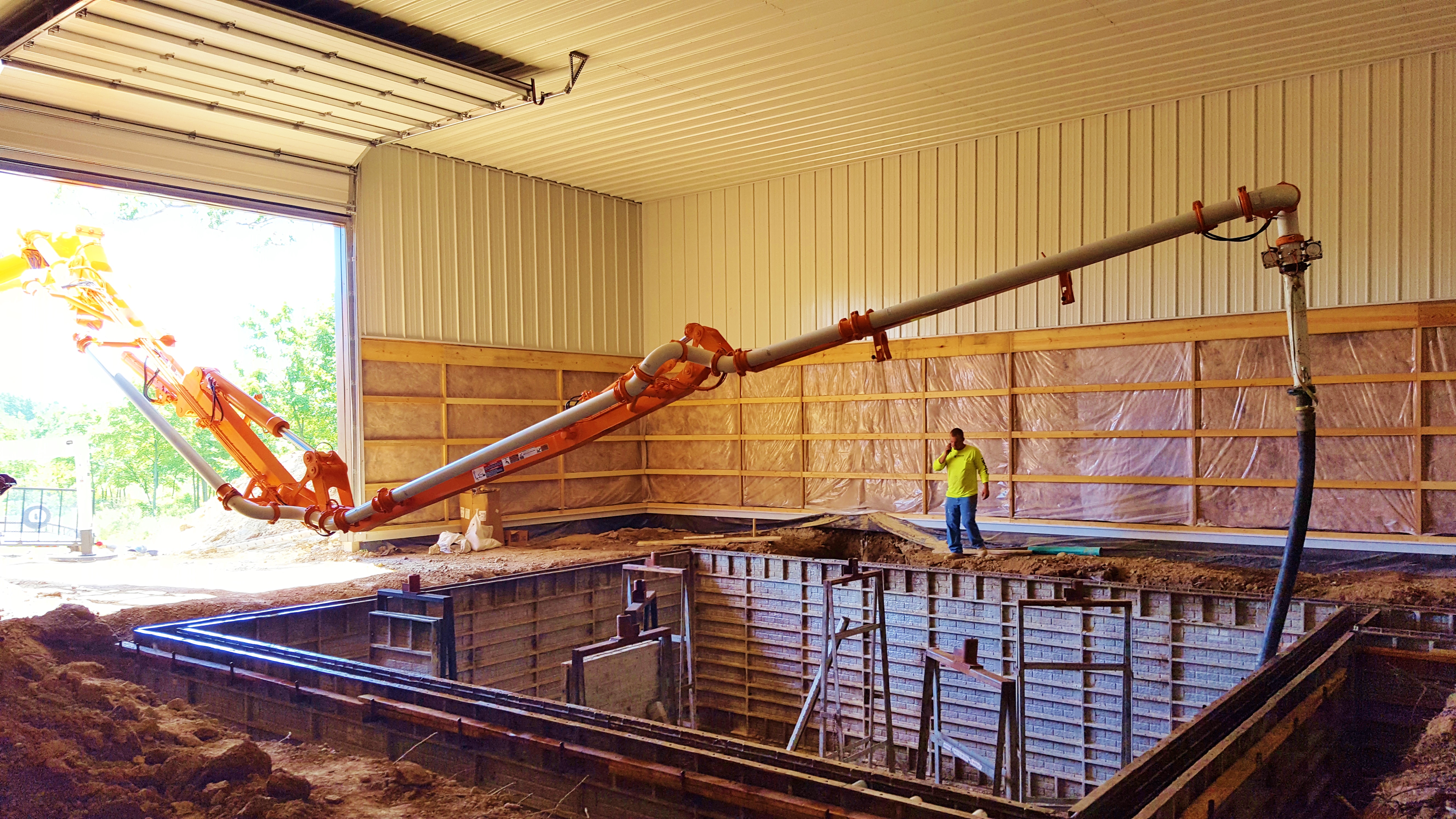 Custom Concrete Pumping helps build the concrete walls in a residential bunker with the 31 meter truck.