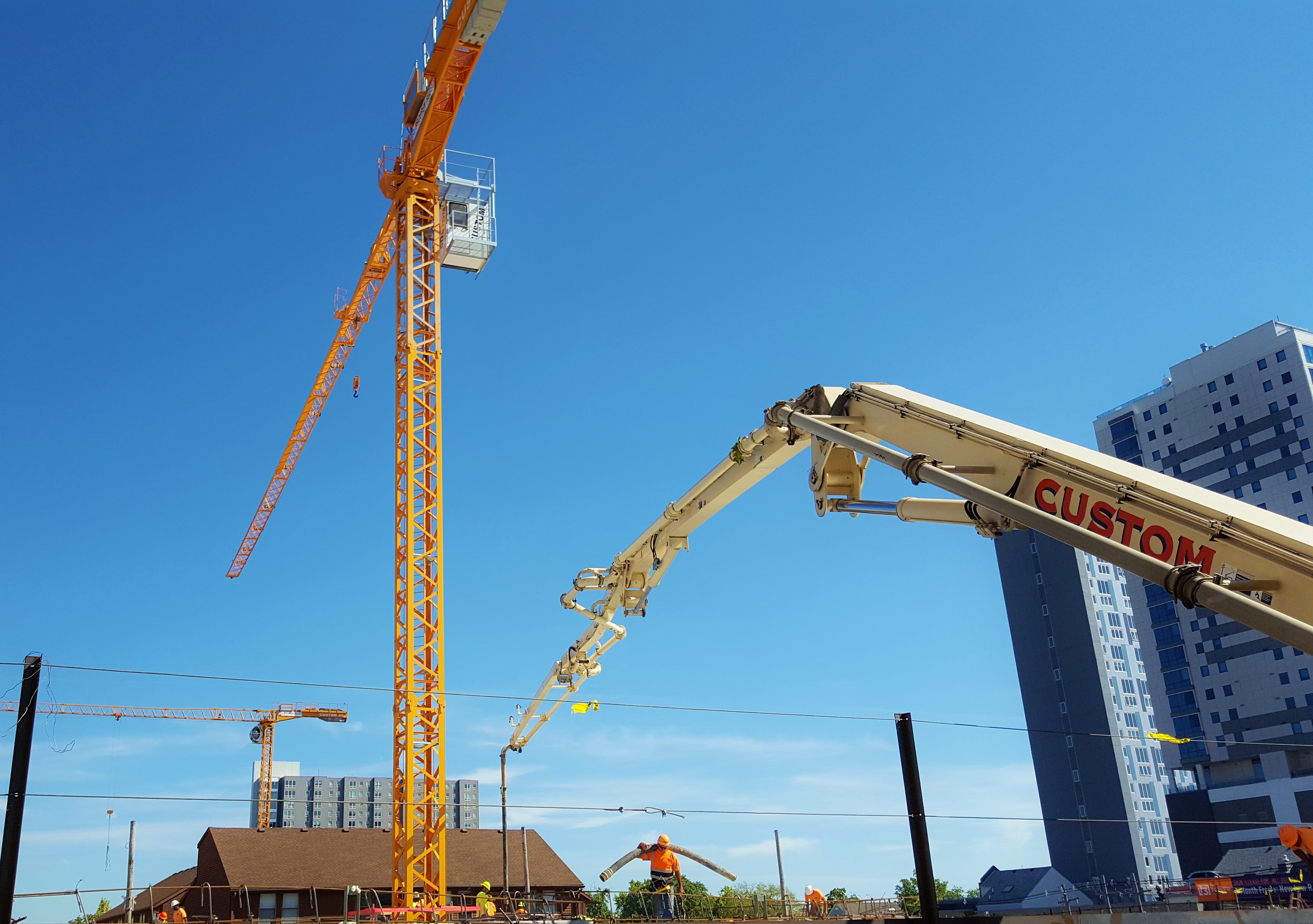 CSCs 39 meter pump truck, tower cranes, and employees work hard at apartment complex in Champaign, IL.
